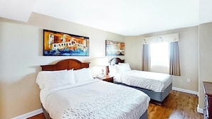 A hotel room with two beds, a window with curtains, and two paintings on the wall. - Carolinian Beach Resort 1735 (Myrtle Beach)