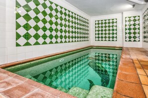 A swimming pool with green and white checkered tiles on the walls and floor. - The Sunny Coast Golf Retreat—5 minutes from Sotogrande (San Roque)