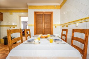 A dining area with a table set for breakfast, including plates, cups, and a croissant. - The Sunny Coast Golf Retreat—5 minutes from Sotogrande (San Roque)