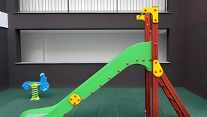 A children's play area with a slide and climbing structure.