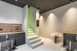 A modern interior with a staircase, bar area, and seating. - Bed and Breakfast 'Vicolo Del Fortino - Suite 105' with Balcony, Wi-Fi and Air Conditioning (Catania)