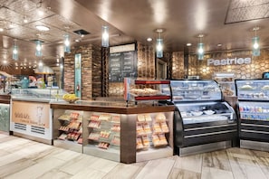 A bakery counter with a menu board, display cases, and a sign for pastries. - Marriott's Aruba Surf Club is on the oceanfront. T (Noord)