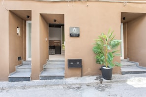 A building facade with a sign indicating a B&B, a staircase, and a potted plant. - Bed and Breakfast 'Vicolo Del Fortino - Camera 104' with Balcony, Wi-Fi and Air Conditioning (Catania)