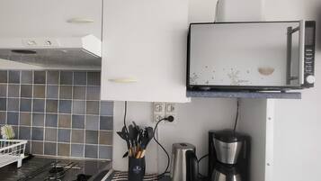 Een koffiezetapparaat/waterkoker, een koelkast, een magnetron