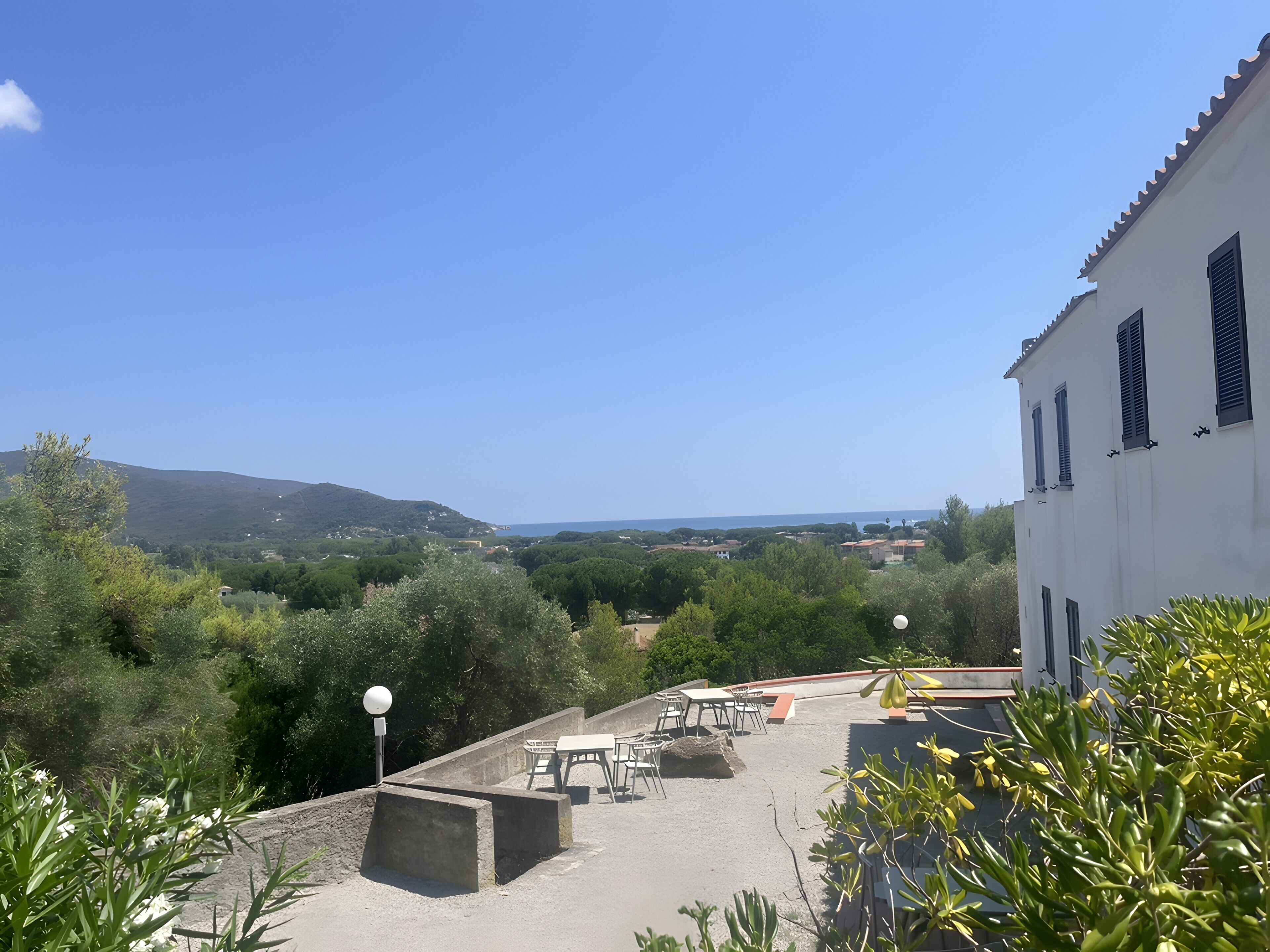 Terraza en la azotea con asientos al aire libre y vista de un paisaje costero.