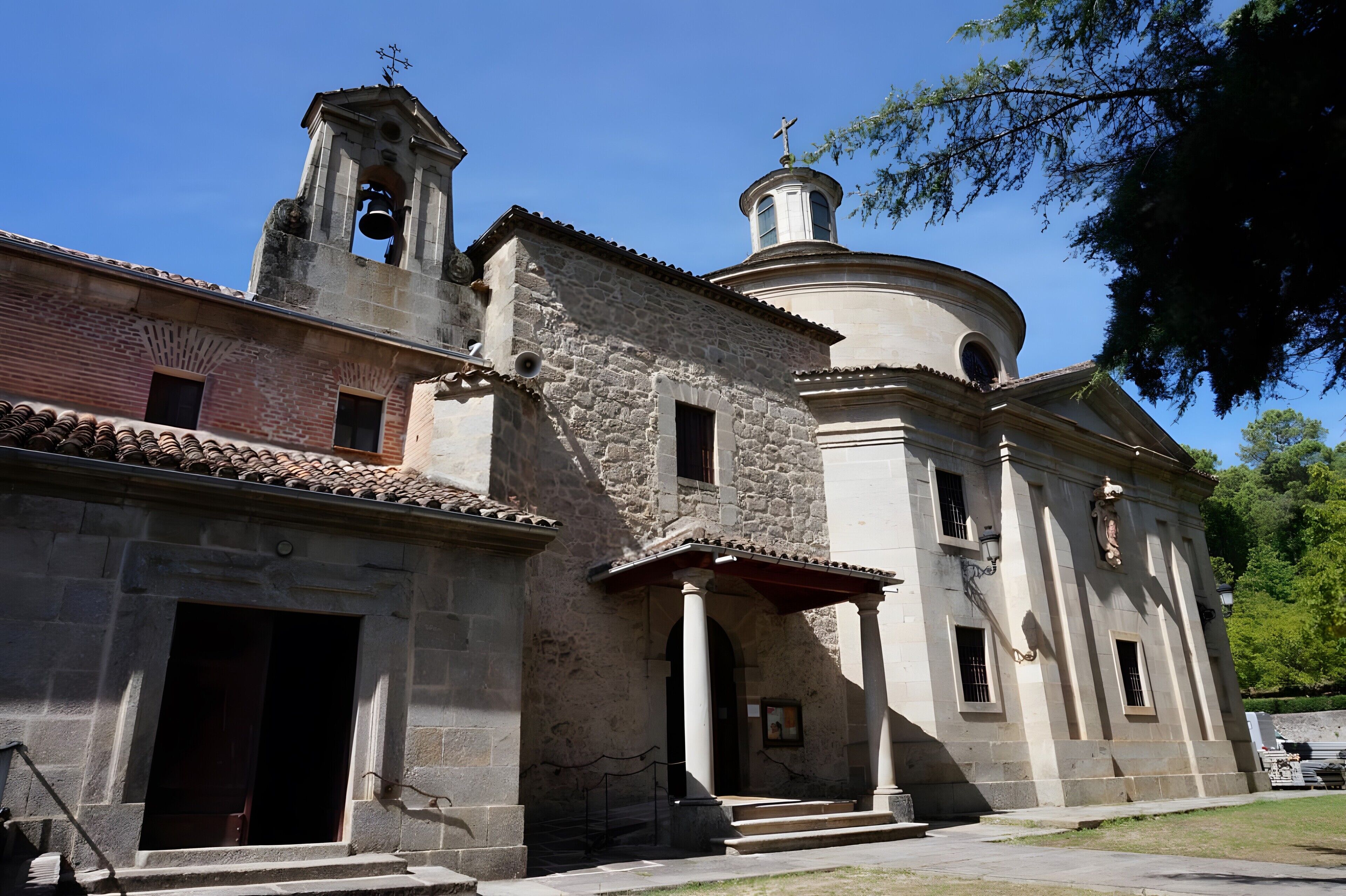 A historical building with a bell tower, a dome, and a bell.