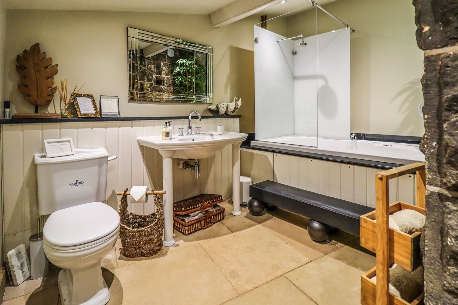 A bathroom with a toilet, sink, and shower.