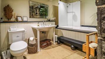 A bathroom with a toilet, sink, and shower.