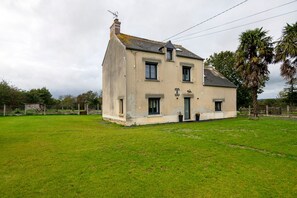 A two-story house with a large front lawn, a chimney, and a sign indicating it is a private residence.