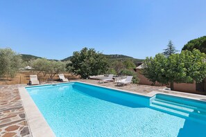 A rectangular swimming pool with clear blue water, surrounded by stone tiles and equipped with lounge chairs. - House 'Chez N E L' with Private Pool and Garrigue View (La Tour-sur-Orb)