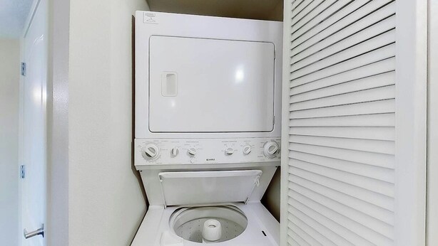 A compact laundry room with a washing machine and dryer. - Carolinian Beach Resort 1830 (Myrtle Beach)