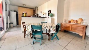 A dining area with a round table, chairs, and a buffet counter. - Apart with loggia overlooking the canal, parking (La Rochelle)