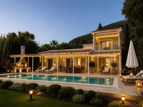 A two-story house with a swimming pool, outdoor seating, and a barbecue area.