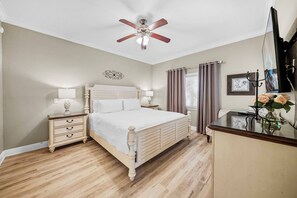 A bedroom with a bed, nightstands, a desk, a ceiling fan, and a window with curtains. - 3BR house with private pool in Reunion Resort (Kissimmee)