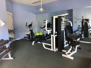 A gym with exercise equipment, a treadmill, and green exercise balls. - Ground floor 2 Bedroom One Bathroom Condo in gated community with Pool (Seminole)