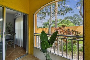 A balcony with a view of trees and a garden. - Ground floor 2 Bedroom One Bathroom Condo in gated community with Pool (Seminole)