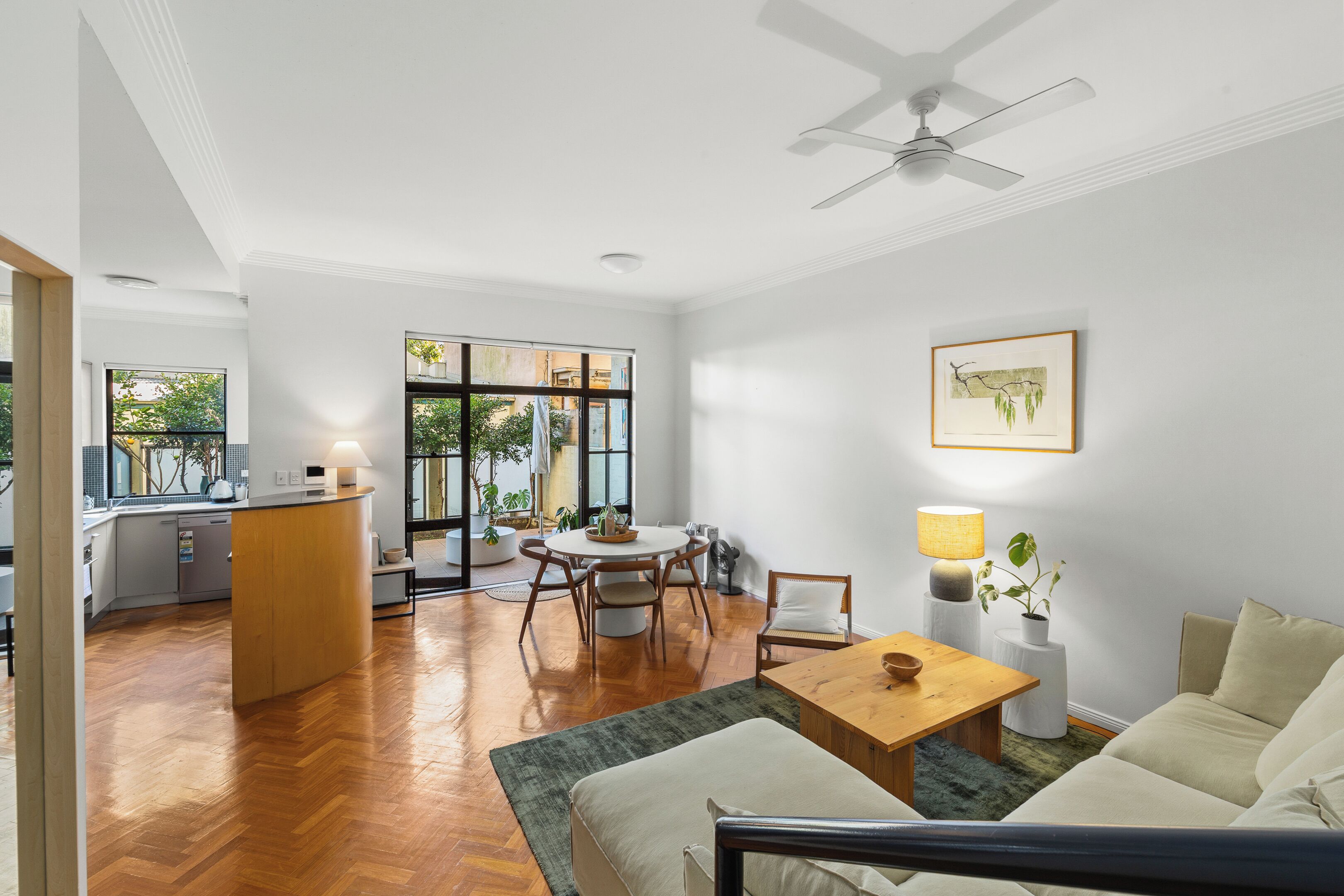 A modern interior with a dining area, kitchen, and seating space.