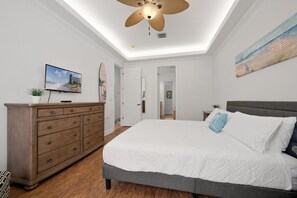 A bedroom with a bed, dresser, ceiling fan, and artwork on the walls. - Game Room • Arcade Games • Private Pool   • Guest House • 7521 (Kissimmee)