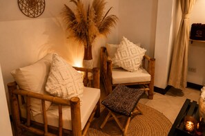 A cozy seating area with two wooden chairs, a small table, and a decorative plant. - private villa 4bedroom 5 bathrooms ,private pool,  beach just a 1-minute to walk (Surat Thani)