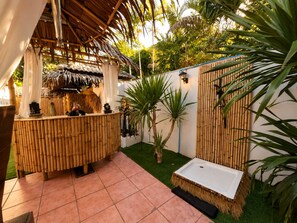 A covered outdoor area with a bamboo fence, a small pool, and a thatched roof structure. - private villa 4bedroom 5 bathrooms ,private pool,  beach just a 1-minute to walk (Surat Thani)