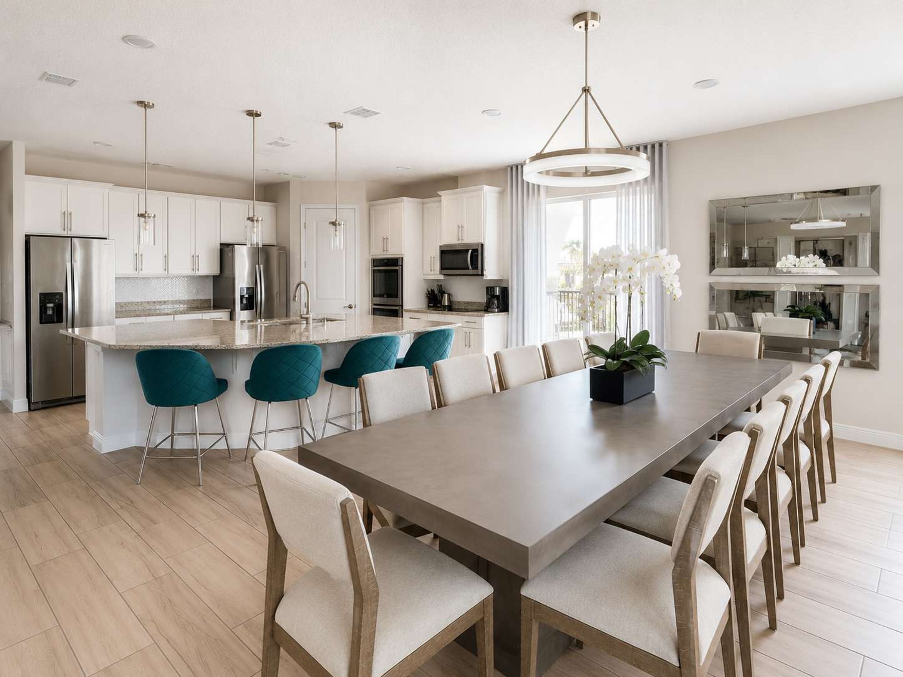 A modern kitchen with a central island, bar stools, and a dining area with a long table and chairs.