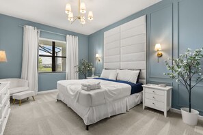 A bedroom with a large bed, a bedside table, a chair, and a window with curtains. - The Premiere House - 8 Mins to Universal Studios 3 Mins to Sea World 15 Mins to Disney World (Orlando)