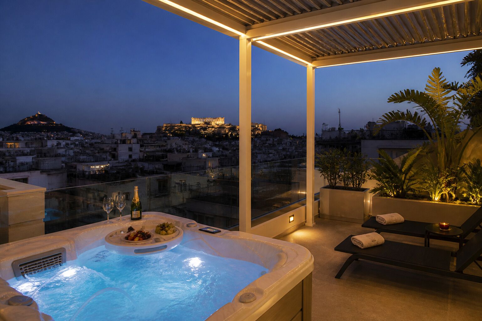 A rooftop terrace with a hot tub, seating area, and a view of a cityscape at dusk.