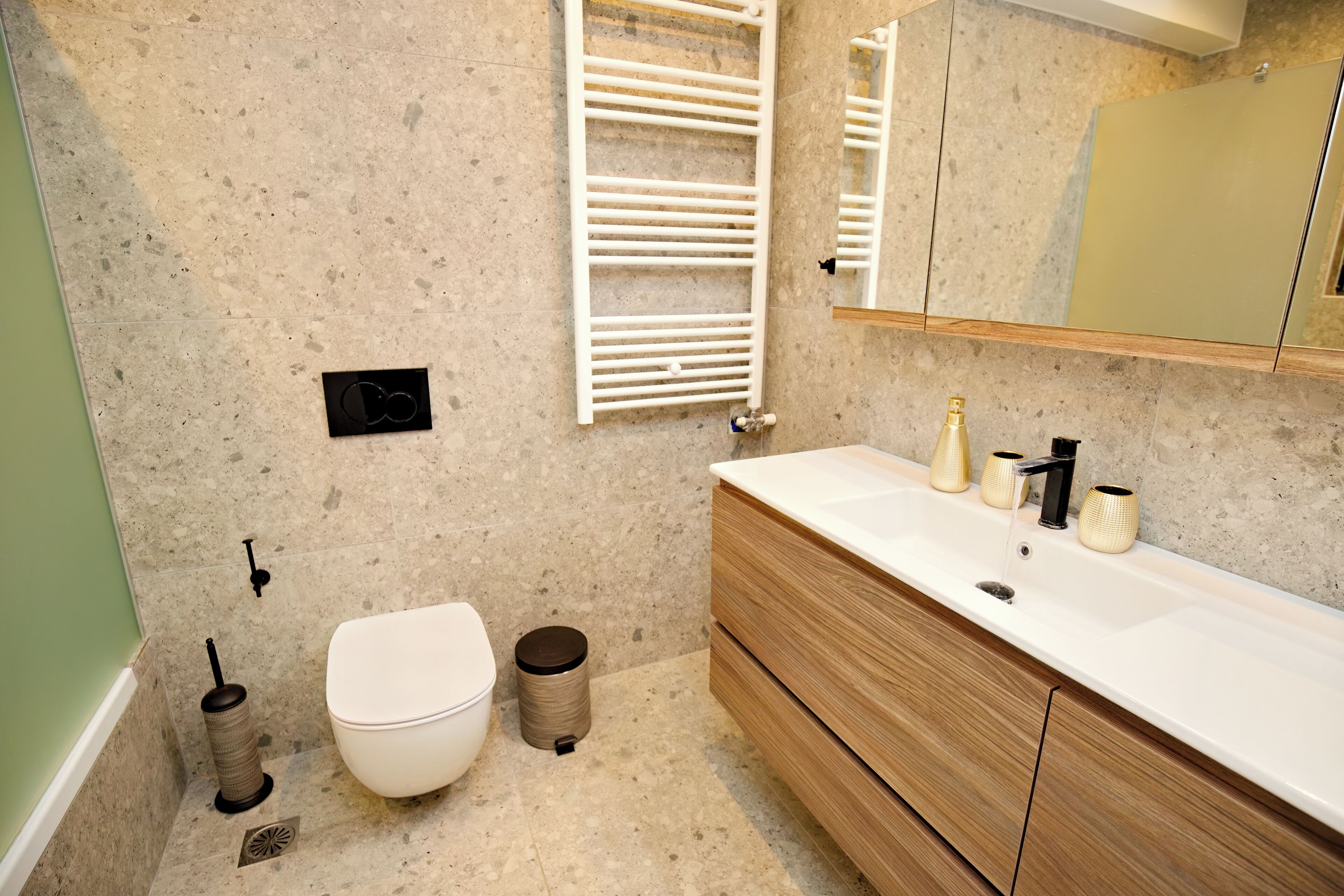 Ein modernes Badezimmer mit Toilette, Waschbecken und Spiegel.