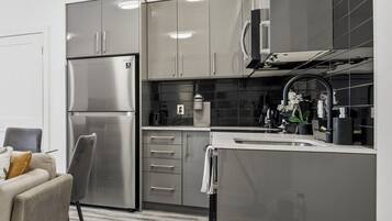 A modern kitchen with stainless steel appliances, a built-in oven, and a microwave.