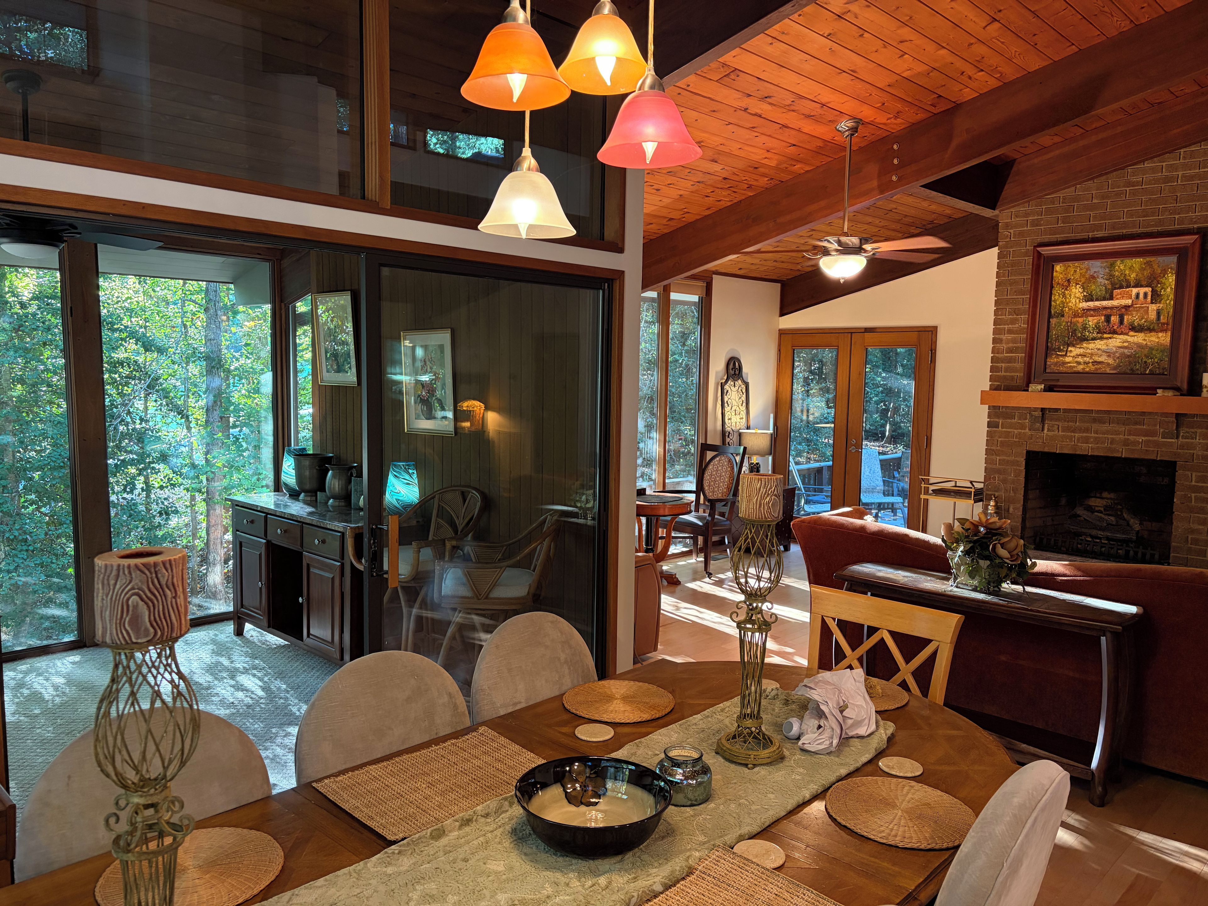 A dining area with a wooden table, chairs, and a fireplace.