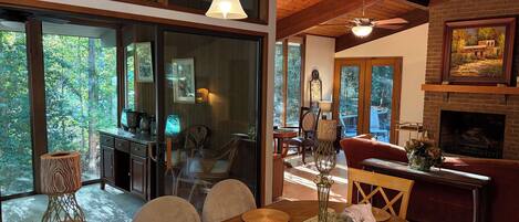 A dining area with a wooden table, chairs, and a fireplace.