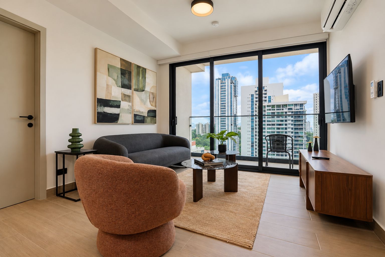 A modern living room with a sofa, a chair, a coffee table, and a TV.