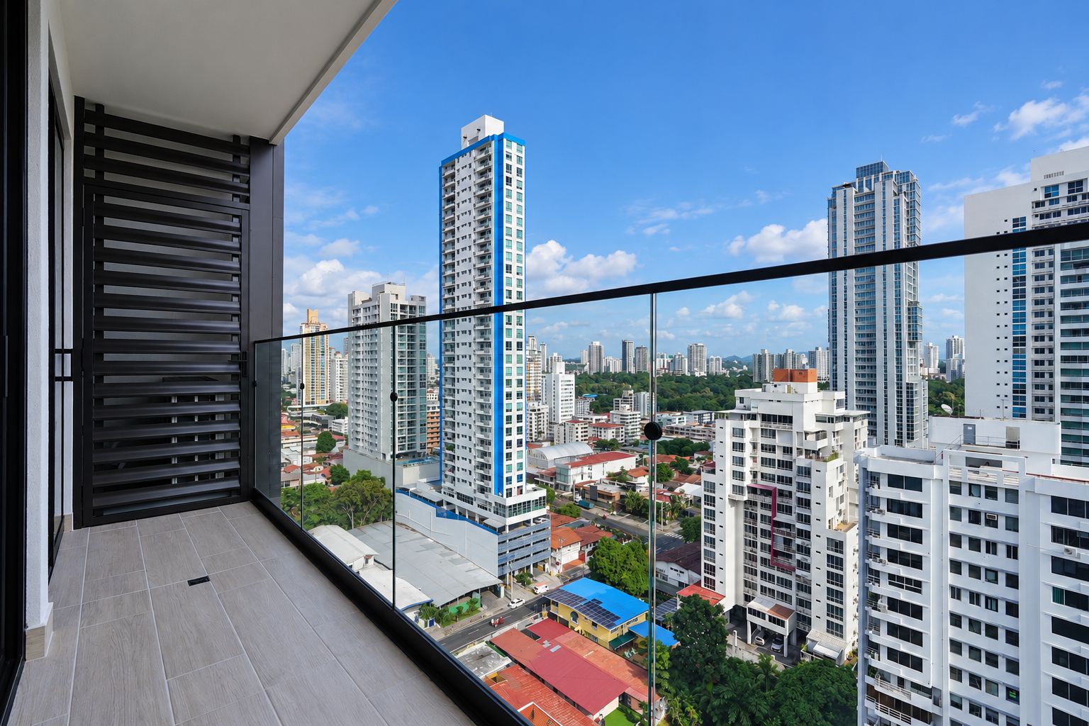 A balcony with a cityscape view, featuring high-rise buildings and a clear sky.