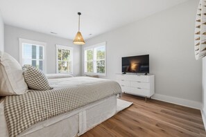 A bedroom with a bed, a television, and a window. - Luxury New Build with Lake Norman Views & Resort Amenities- Sleeps 16 (Lake Norman of Catawba)