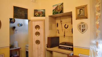 A compact kitchen with a stove, sink, and various kitchen utensils.