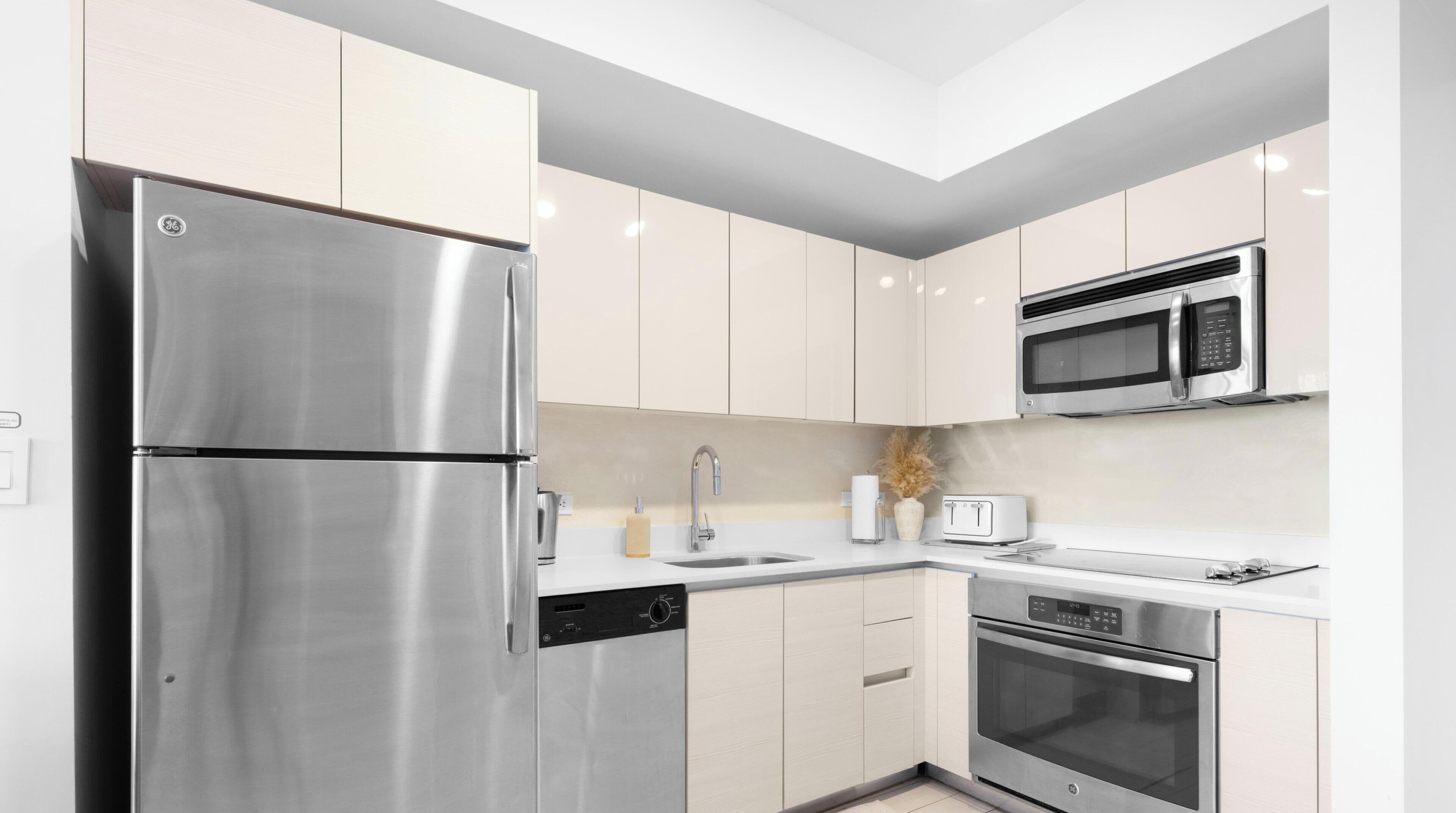 A modern kitchen with stainless steel appliances, a microwave, and a dishwasher.