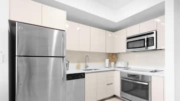 A modern kitchen with stainless steel appliances, a microwave, and a dishwasher.