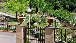 A gated garden area with a "PRIVATE" sign, a lamp post, and potted plants. - Homerez - House in Gattaia with pool (Gattaia)