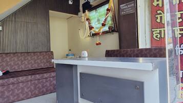 A reception desk with a computer monitor, a telephone, and a water dispenser.
