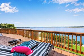 A deck with lounge chairs and a view of a body of water. - Canyon Lake FRONT-3 Story-Sleeps 12-Game FLOOR-Free Kayaks!  BEST Amenities! (Canyon Lake)