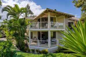 A two-story house with a balcony, surrounded by lush greenery. - Ocean View 6BR, 2 Condos for 16 in Wailea, Hawaii! (Wailea)
