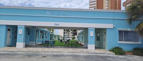 A hotel named Monterey with a covered entrance and outdoor seating area.