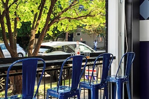 A row of blue chairs outside a building with a sign that reads "Walgreens Welcome". - The Stables 2 - Minigolf, Firepits, Games, BBQ (Louisville)