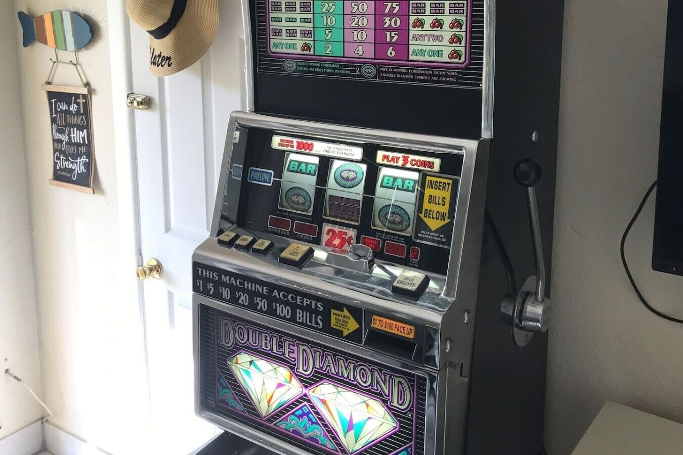 A slot machine with a 'DOUBLE DIAMOND' theme, accepting bills of $1, $5, $10, $20, $50, and $100.