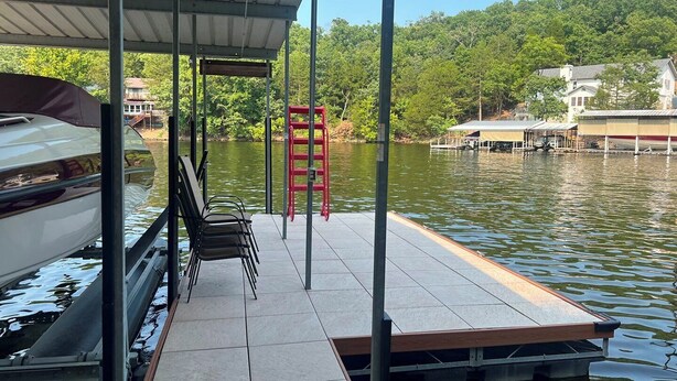 A dock with a covered seating area, a red ladder, and a boat. - Timber Ridge - Three Bedroom House, Sleeps 8 (Village of Four Seasons)