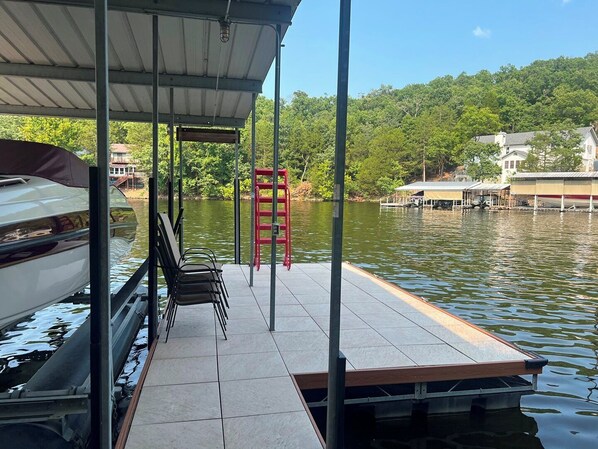 A dock with a covered seating area, a red ladder, and a boat. - Timber Ridge - Three Bedroom House, Sleeps 8 (Village of Four Seasons)