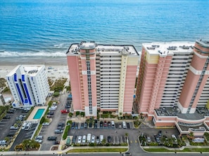 A multi-story hotel with a pool, parking, and a beach view. - North Myrtle Beach Oceanview Condo (North Myrtle Beach)