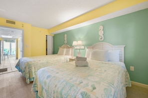 A hotel room with two beds, a seahorse wall decoration, and a view of the outside. - North Myrtle Beach Oceanview Condo (North Myrtle Beach)