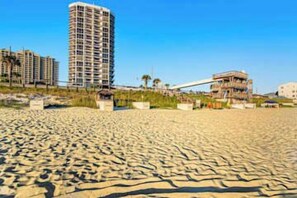 A sandy beach with buildings in the background. - Ocean View Resort Condo, Private Balcony, & Shared Hot Tub, Pool, Tennis (Miramar Beach)