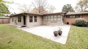 A single-story house with a covered patio, a front door, and a garage.